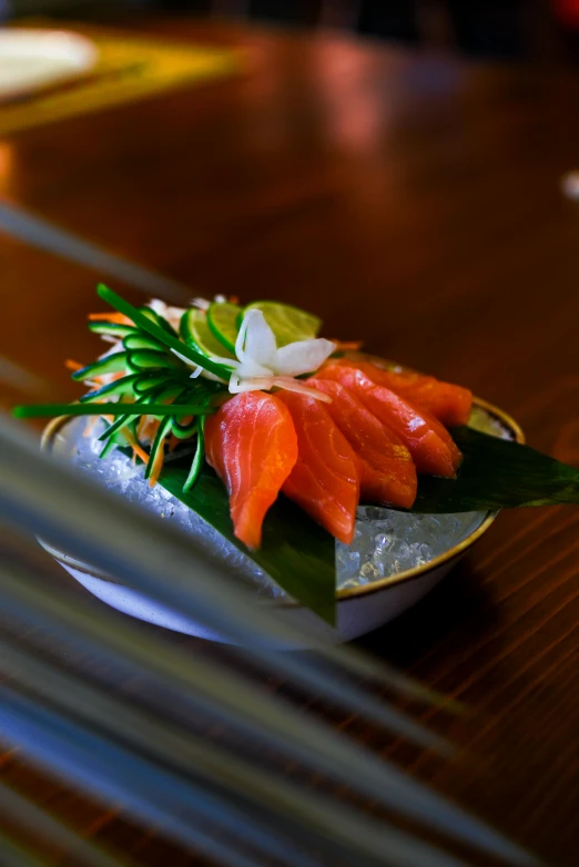 a close up of a plate of food on a table, shin hanga, salmon, draped with water and spines, lush, uplit