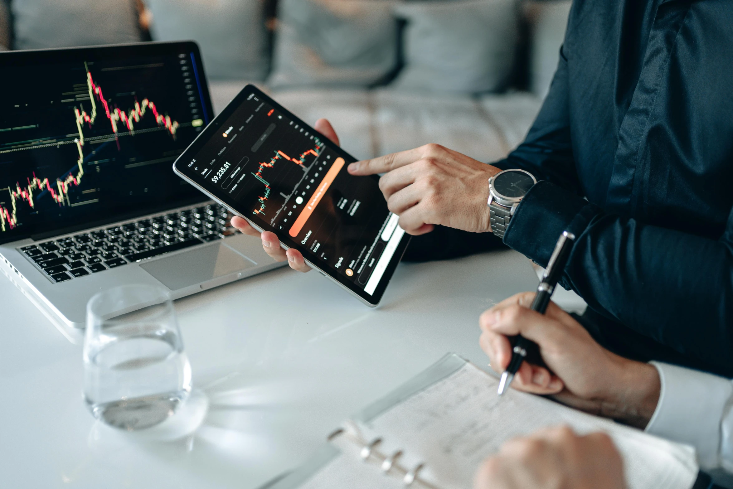 a couple of people sitting at a table with laptops, trending on pexels, analytical art, displaying stock charts, writing on a clipboard, thumbnail, wētā fx