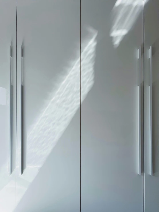 a couple of white cupboards sitting next to each other, inspired by Shigeru Aoki, unsplash, light and space, long cast shadows, icicle, close up details, natural lighting. 8 k