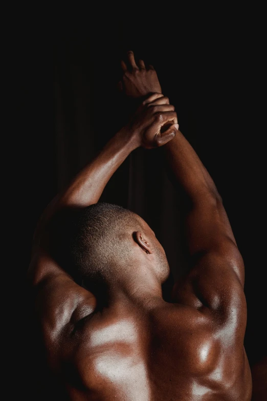 a man flexing his muscles in the dark, an album cover, by Jessie Alexandra Dick, pexels contest winner, renaissance, ebony skin, back arched, instagram picture, soft smooth skin