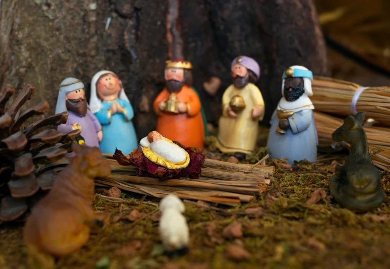 a group of nativity figurines in front of a tree, by Alice Mason, pexels contest winner, high angle close up shot, plasticine models, animation still, thumbnail