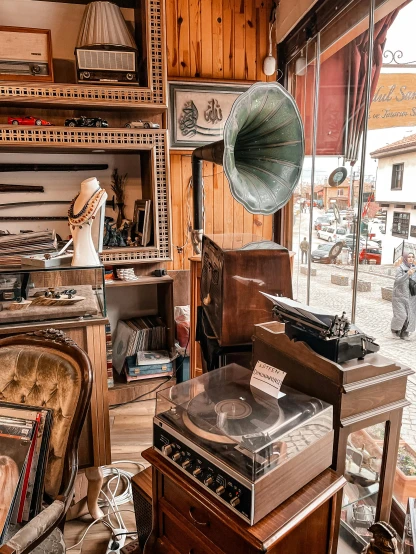 a room filled with furniture and a record player, trending on pexels, art nouveau, turkey, shop front, thumbnail, preserved historical