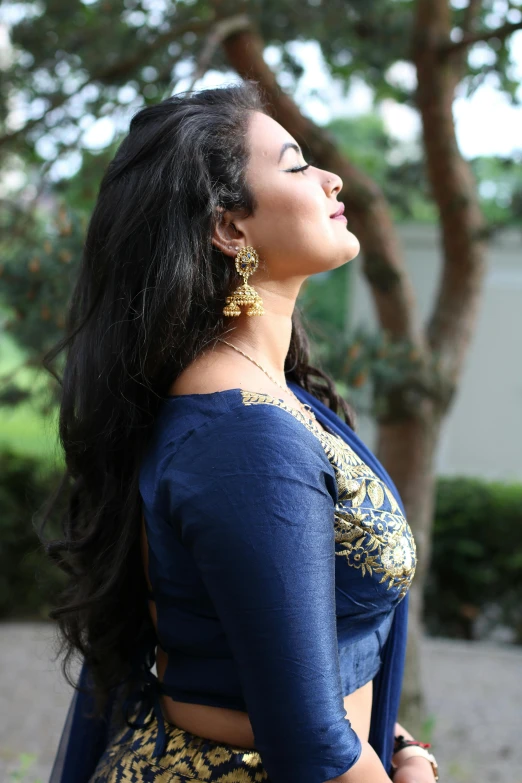 a woman in a blue sari posing for a picture, trending on cg society, in a navy blue sweater, curves!!, profile image, large)}]