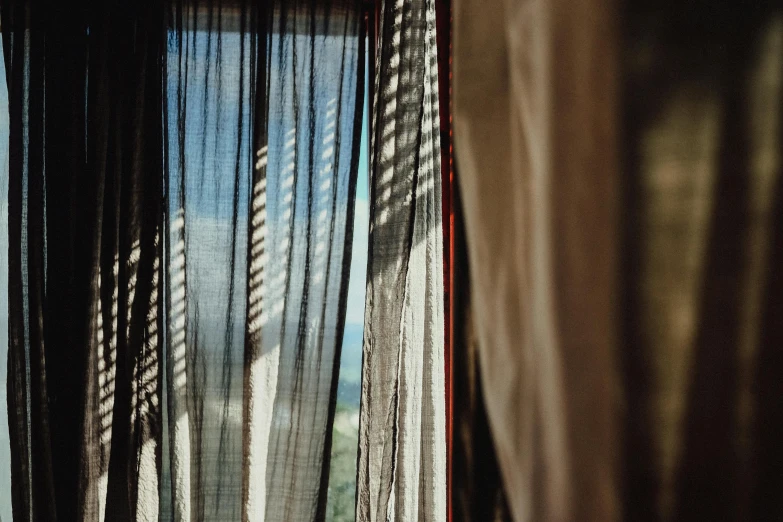 a close up of a curtain in front of a window, inspired by Elsa Bleda, unsplash, light and space, summer afternoon, alessio albi, conde nast traveler photo, scenic view