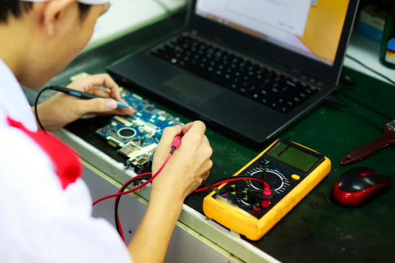 a man that is sitting in front of a laptop, red hot soldering iron, electrical case display, avatar image, motherboard circuitry