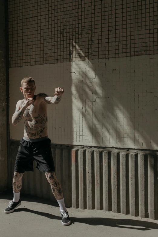 a man hitting a tennis ball with a racket, a tattoo, pexels contest winner, graffiti, mma southpaw stance, gif, caspar david, with backdrop of natural light