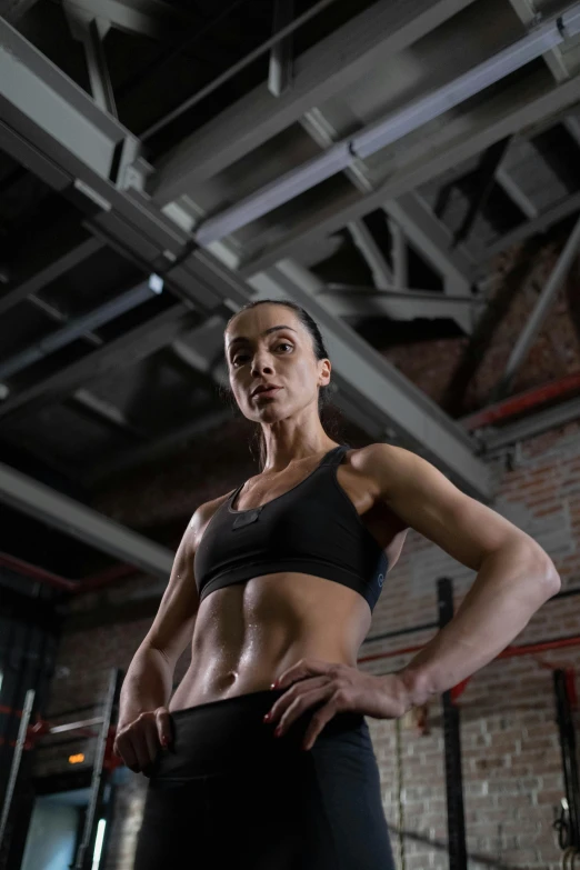 a woman posing for a picture in a gym, a portrait, by Adam Marczyński, promo image, ukrainian, very strong, profile image