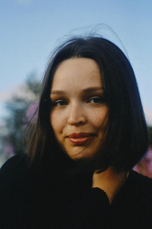 a close up of a person wearing a black shirt, an album cover, natali portman, lovingly looking at camera, taken at golden hour, nettie wakefield