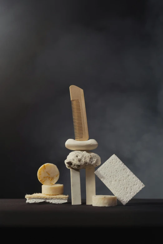 a pile of toothbrushes sitting on top of a table, an abstract sculpture, inspired by Sarah Lucas, assemblage, sea sponges, textured base ; product photos, buildings carved out of stone, molecular gastronomy