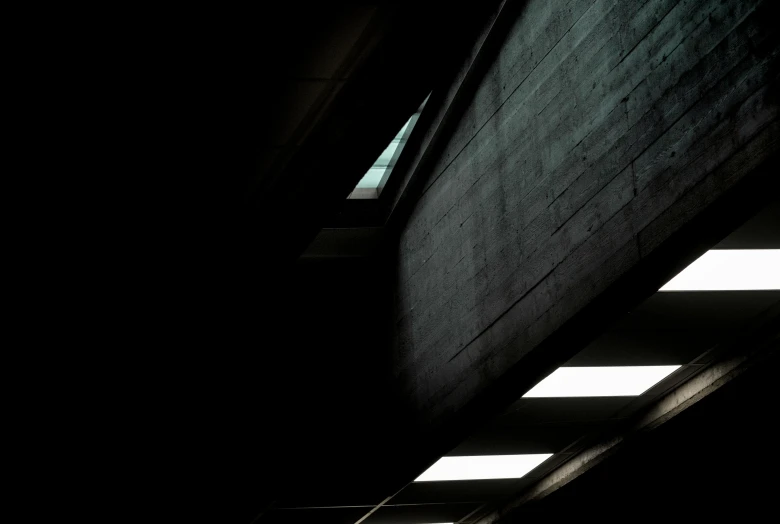 a man riding a skateboard up the side of a building, by Andrew Domachowski, light and space, ceiling hides in the dark, brutalist shiro, abstract conceptual, skylights