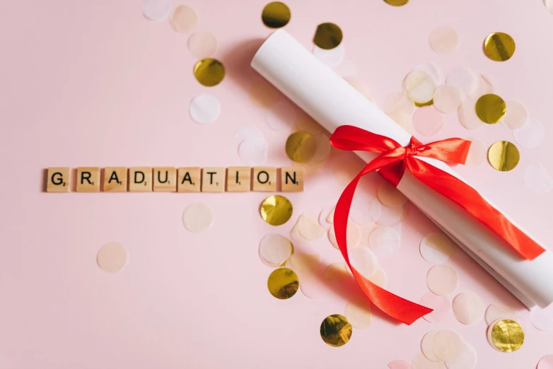 a graduation diploma laying on top of a pile of confetti, by Julia Pishtar, pexels contest winner, pink gradient background, papyrus, white buildings with red roofs, letters