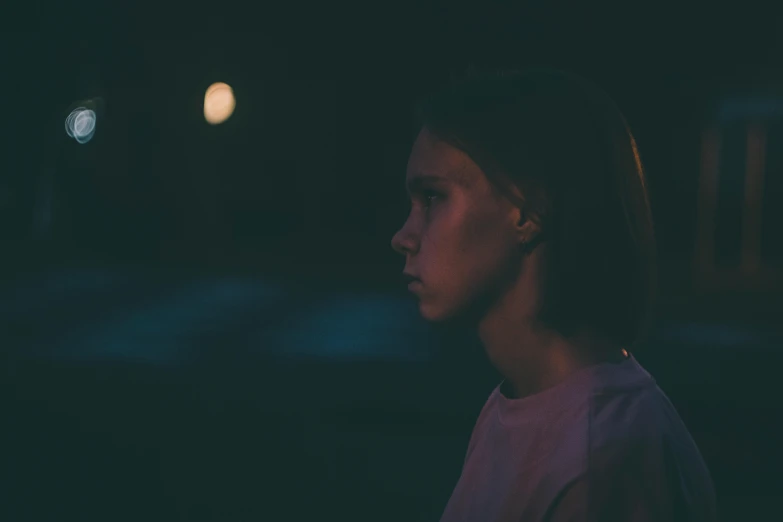 a woman standing in the dark at night, pexels contest winner, realism, sophia lillis, eleven/millie bobbie brown, girl under lantern, distant photo