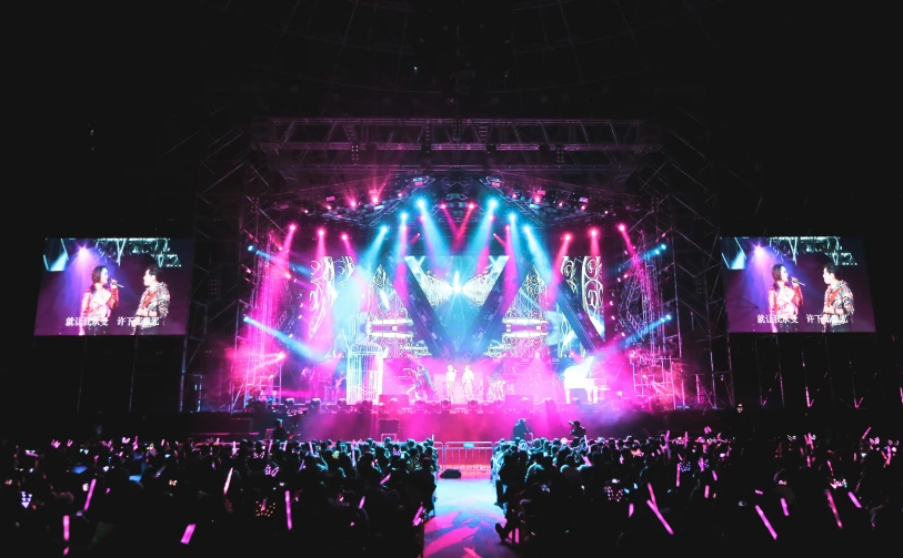 a group of people that are standing in front of a stage, violet and aqua neon lights, stage speakers, instagram post, dramatic stadium lighting