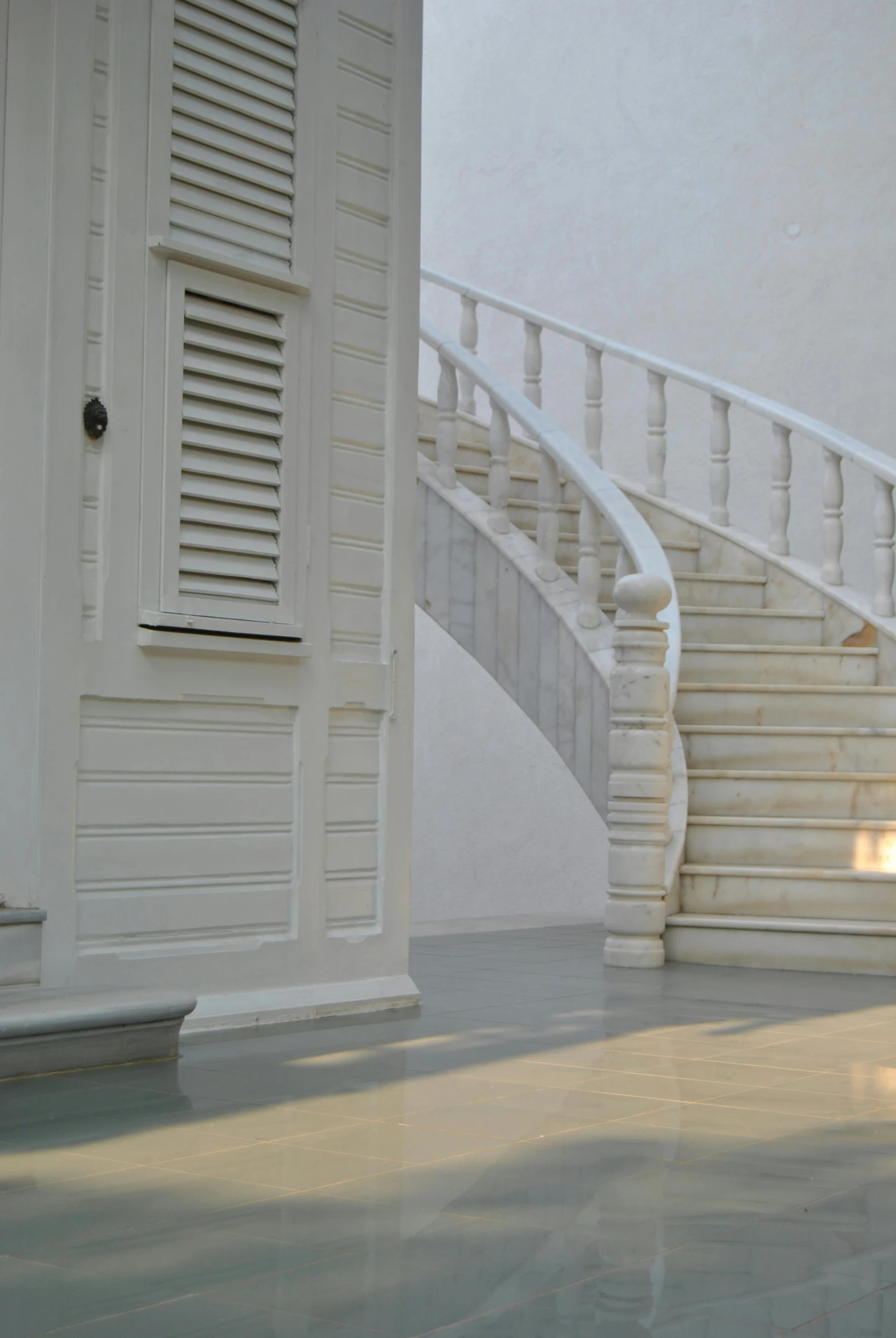 a man riding a skateboard down a flight of stairs, inspired by Pierre-Joseph Redouté, baroque, made of carrara marble, white picket fence, white marble interior photograph, shutters