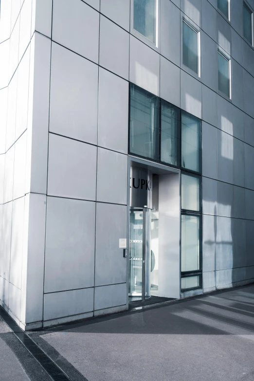 a man riding a skateboard down a sidewalk next to a tall building, a picture, unsplash, bauhaus, door to lab, ((((unreal engine)))), metal cladding wall, private academy entrance