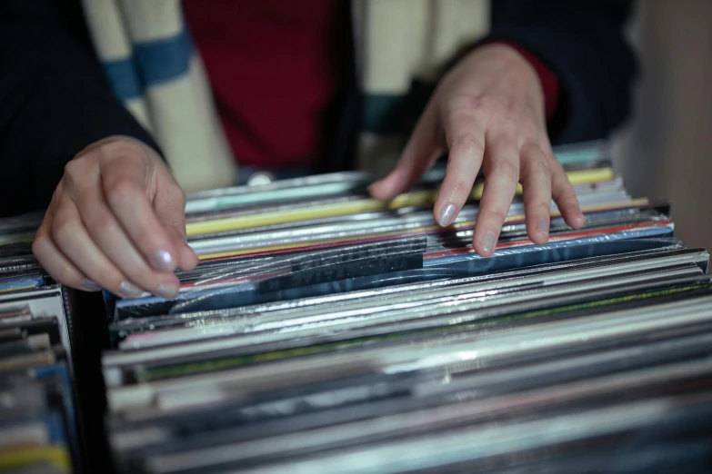 a close up of a person holding a bunch of records, by Matthias Stom, unsplash, 15081959 21121991 01012000 4k, digging, market, ultradetailed