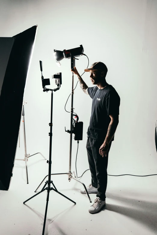 a man that is standing in front of a camera, a picture, film lighting, set against a white background, production ig, grey backdrop