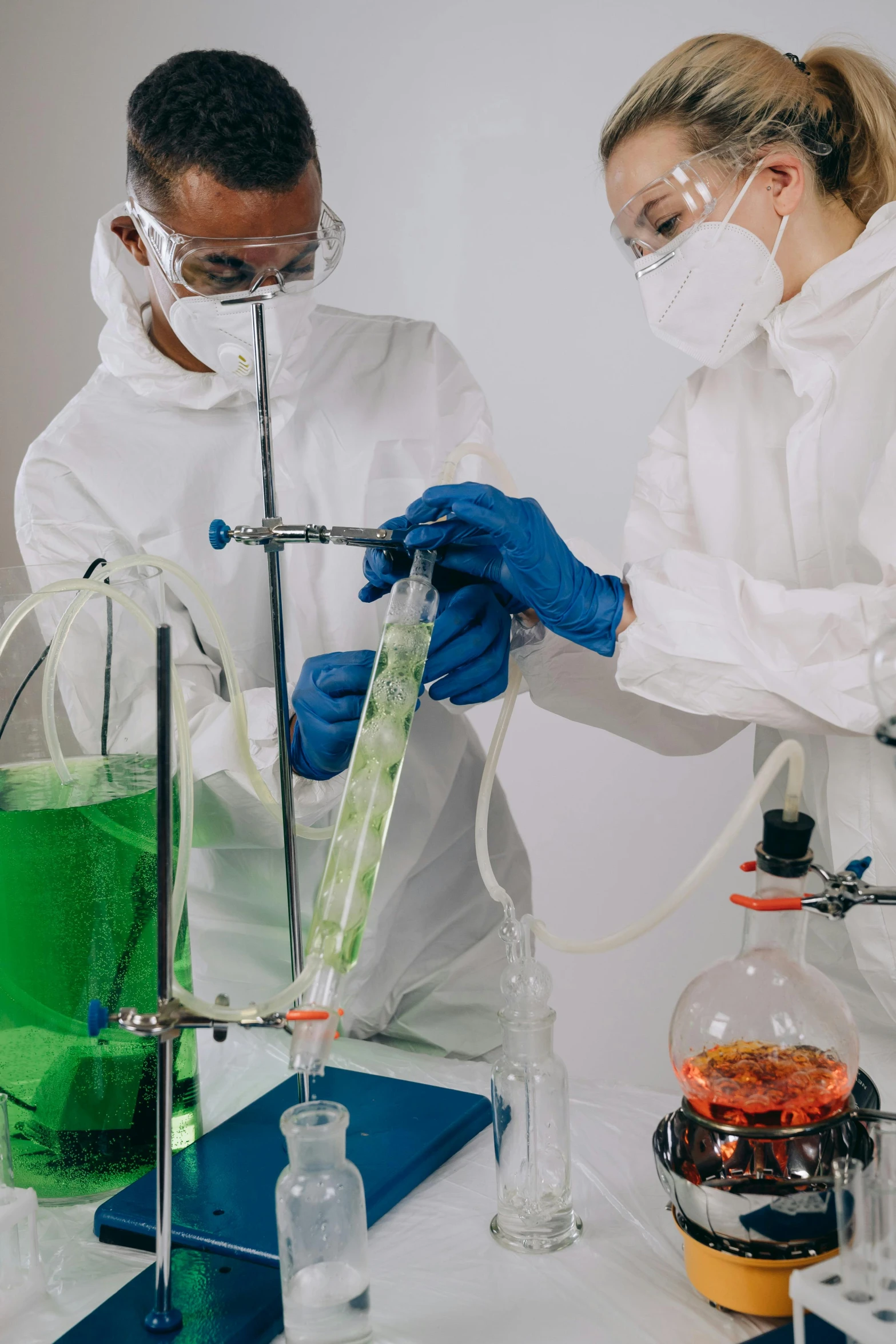 a couple of people that are in a lab, an album cover, shutterstock, spraying liquid, fluid bag, biotechnology, plating