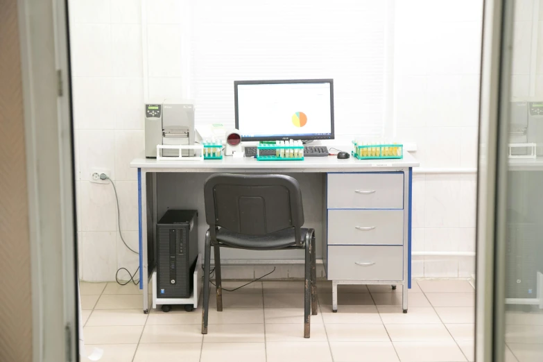 a computer sitting on top of a desk next to a chair, danube school, medical laboratory, white wall coloured workshop, profile image, product display