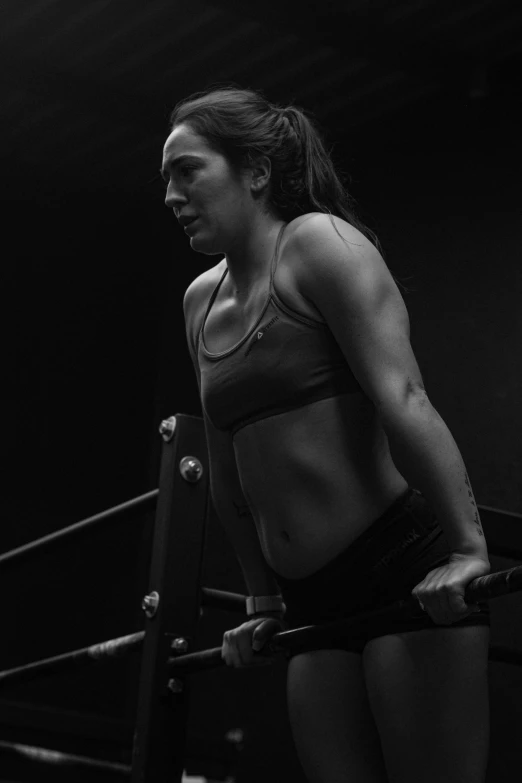 a black and white photo of a woman in a boxing ring, curvy crossfit build, nighttime!, female ascending, kailee mandel