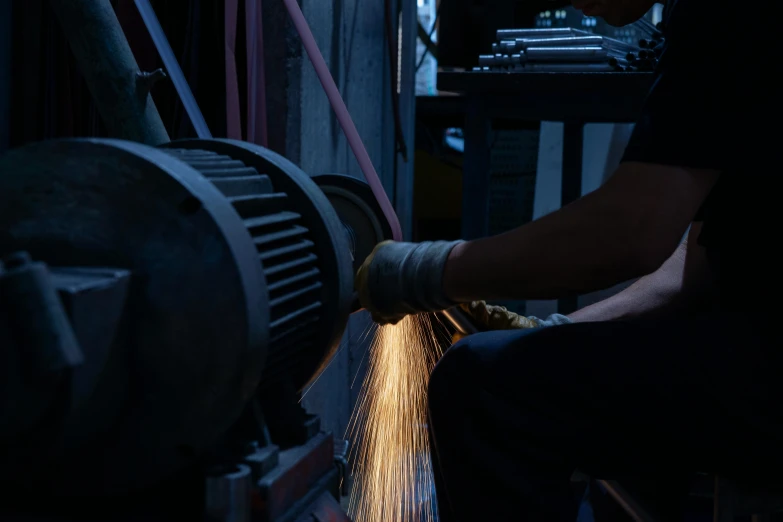 a man grinding metal with a grinder, by Adriaen Hanneman, pexels contest winner, fan favorite, factory background, close to night, profile image