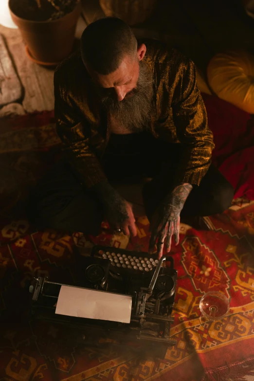 a man sitting on the floor working on a laptop, by Elsa Bleda, unsplash contest winner, art & language, an arcane wizard casting a spell, 1 9 2 0's style speakeasy, tattooed, still from a wes anderson film