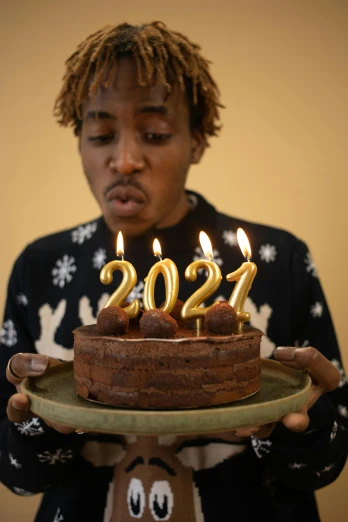 a man holding a cake with candles on it, an album cover, trending on pexels, happening, diverse ages, new years eve, yearbook photo, brown