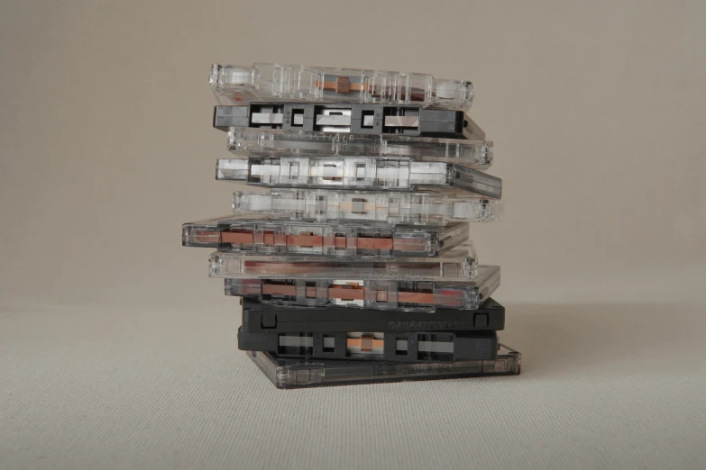 a stack of cassettes sitting on top of each other, by Nina Hamnett, serial art, transparent, oud, lined up horizontally, 1 2 - bit