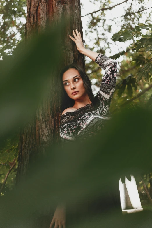 a woman leaning against a tree in a forest, a portrait, inspired by Elsa Bleda, pexels contest winner, arabesque, oona chaplin, photography portrait 4 k, vine covered, foliage clothing