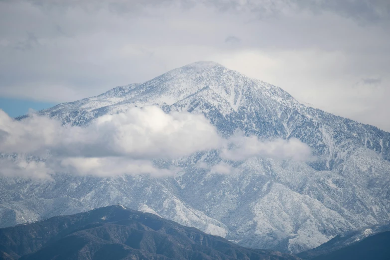 a large mountain covered in snow on a cloudy day, inspired by Kaii Higashiyama, trending on unsplash, palm springs, telephoto, multiple stories, today\'s featured photograph 4k