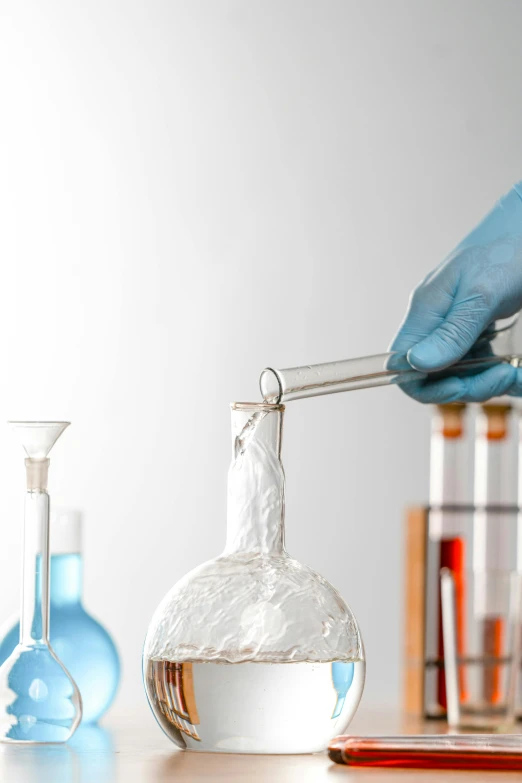 a person in blue gloves is pouring liquid into a flask, a picture, shutterstock, analytical art, detailed product image, brown, syringe, 🦑 design