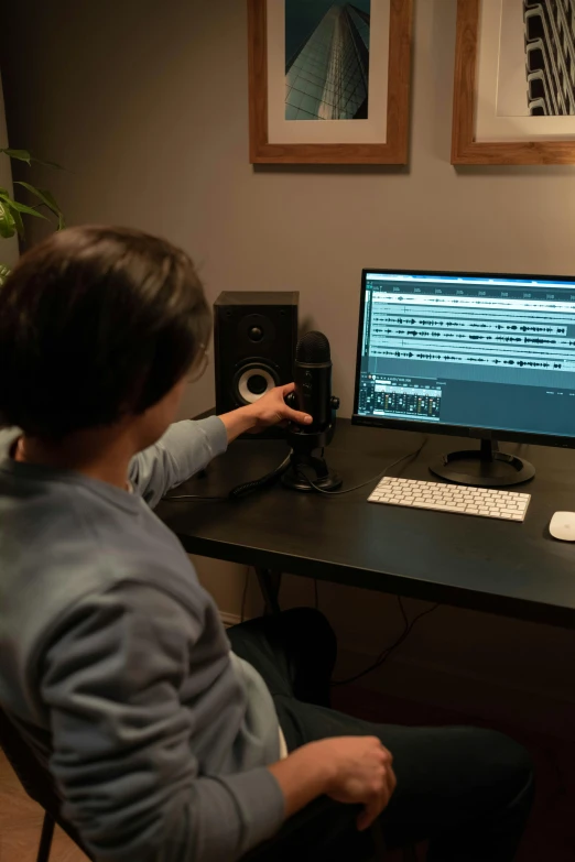 a person sitting at a desk in front of a computer, shogun audio, square, adobe premier pro, promo image