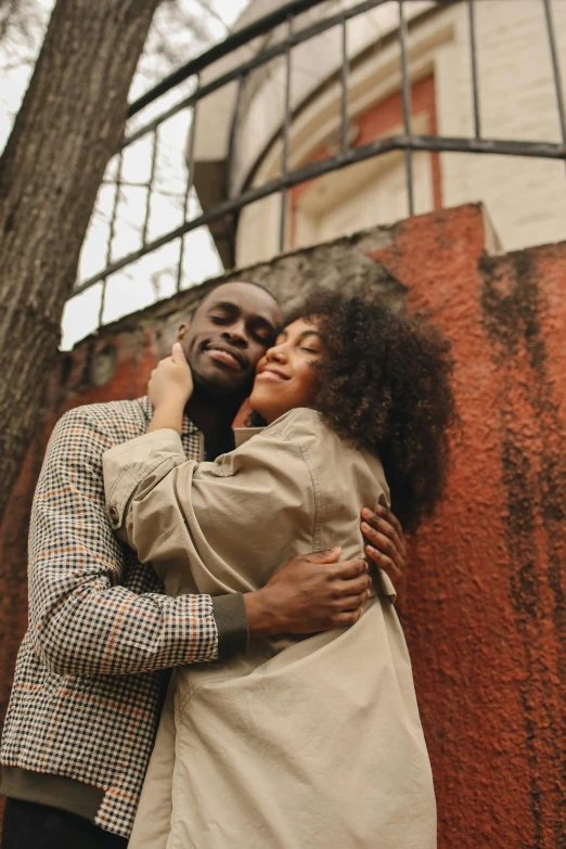 a man and woman hugging in front of a building, pexels contest winner, renaissance, east african man with curly hair, high quality product image”, 1 2 9 7, girls