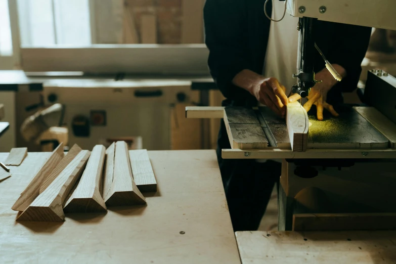 a person cutting a piece of wood with a machine, pexels contest winner, arts and crafts movement, 9 9 designs, alessio albi, midcentury modern, tiffany dover