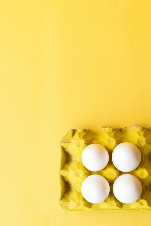 four eggs in a carton on a yellow background, by Carey Morris, trending on unsplash, square, cake, white male, 15081959 21121991 01012000 4k