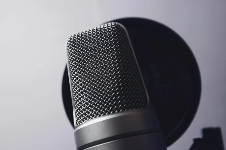 a close up of a microphone on a table, trending on pexels, avatar image, panel of black, on grey background, hyperdetailed mix