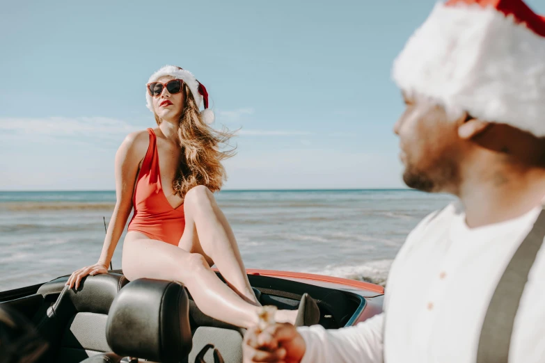 a woman in a santa hat sitting on the back of a boat, pexels contest winner, man grabbing a womans waist, bumper cars, looking at the ocean, avatar image