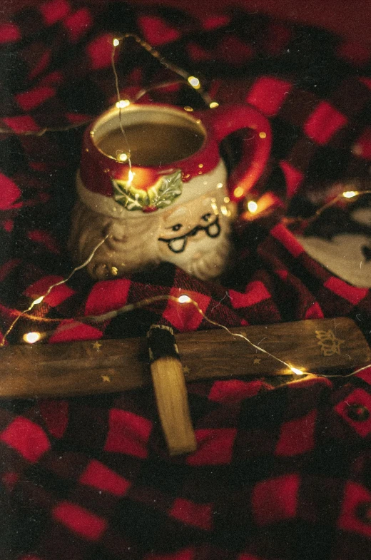 a couple of mugs sitting on top of a table, a portrait, inspired by Ernest William Christmas, pexels, sitting on santa, s'mores, low quality photo, christmas lights