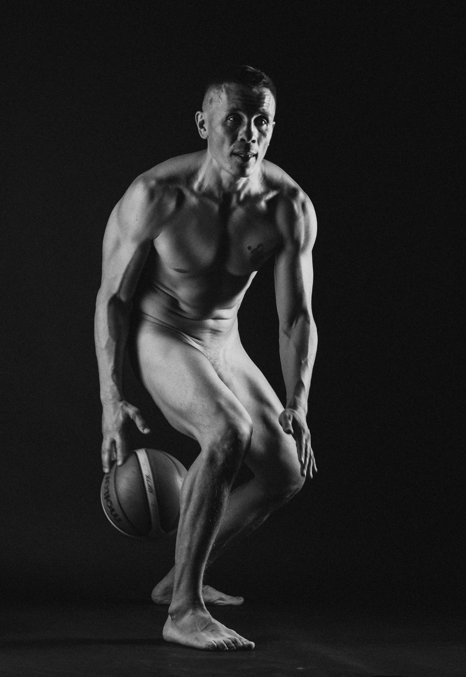 a black and white photo of a man holding a basketball, a statue, inspired by Peter Basch, dribble, art photography, made of flesh and muscles, studio medium format photograph, bodybuilder body, 5 5 yo