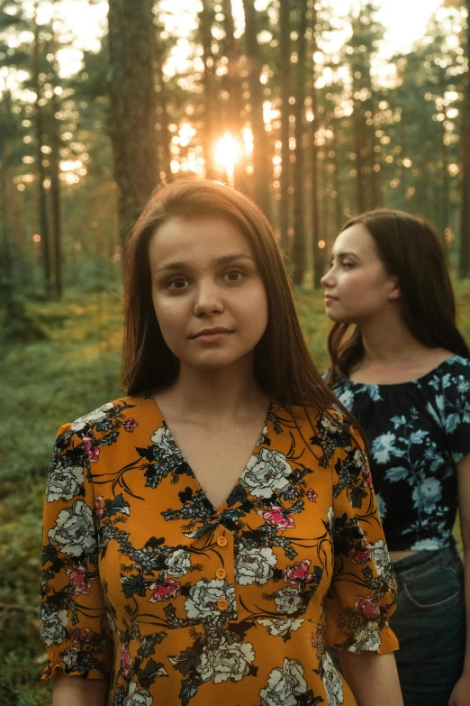 two women standing next to each other in a forest, an album cover, by Adam Marczyński, pexels contest winner, portrait of a young teenage girl, 256435456k film, late summer evening, looking serious