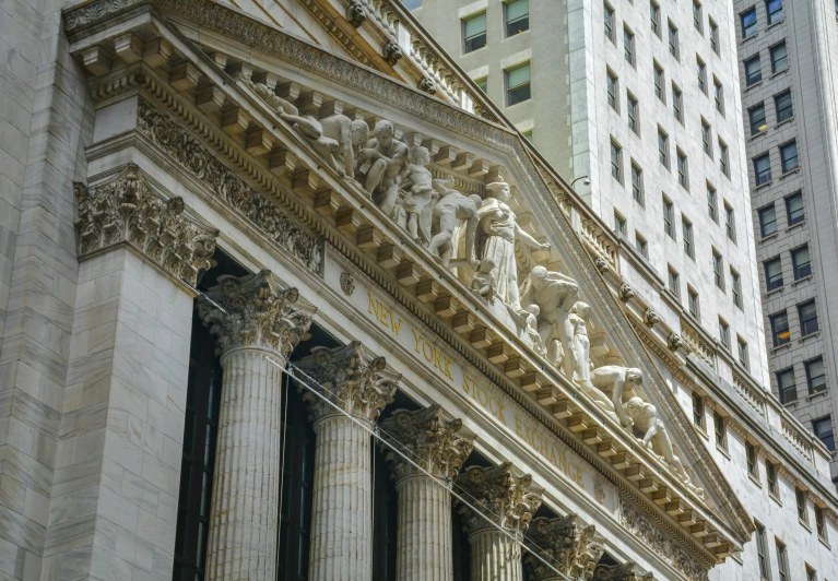 a clock that is on the side of a building, a marble sculpture, trading stocks, canopies, adorned pillars, group photo