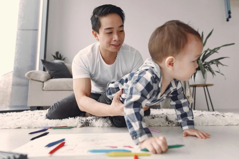 a man playing with a child on the floor, a child's drawing, pexels contest winner, joe taslim, walking to the right, lachlan bailey, asian male