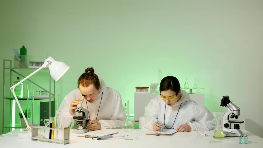 a couple of people sitting at a table with microscopes, profile image, plating, private school, chemical woekshop