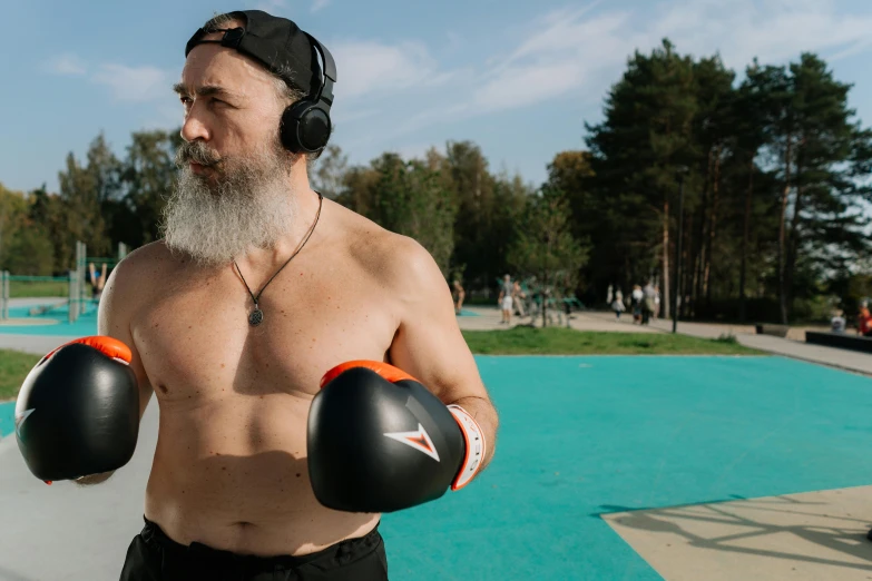 a man with a beard wearing boxing gloves, an album cover, by Julia Pishtar, pexels contest winner, happening, middle - age, tourist photo, alexey egorov, big wide broad strong physique |