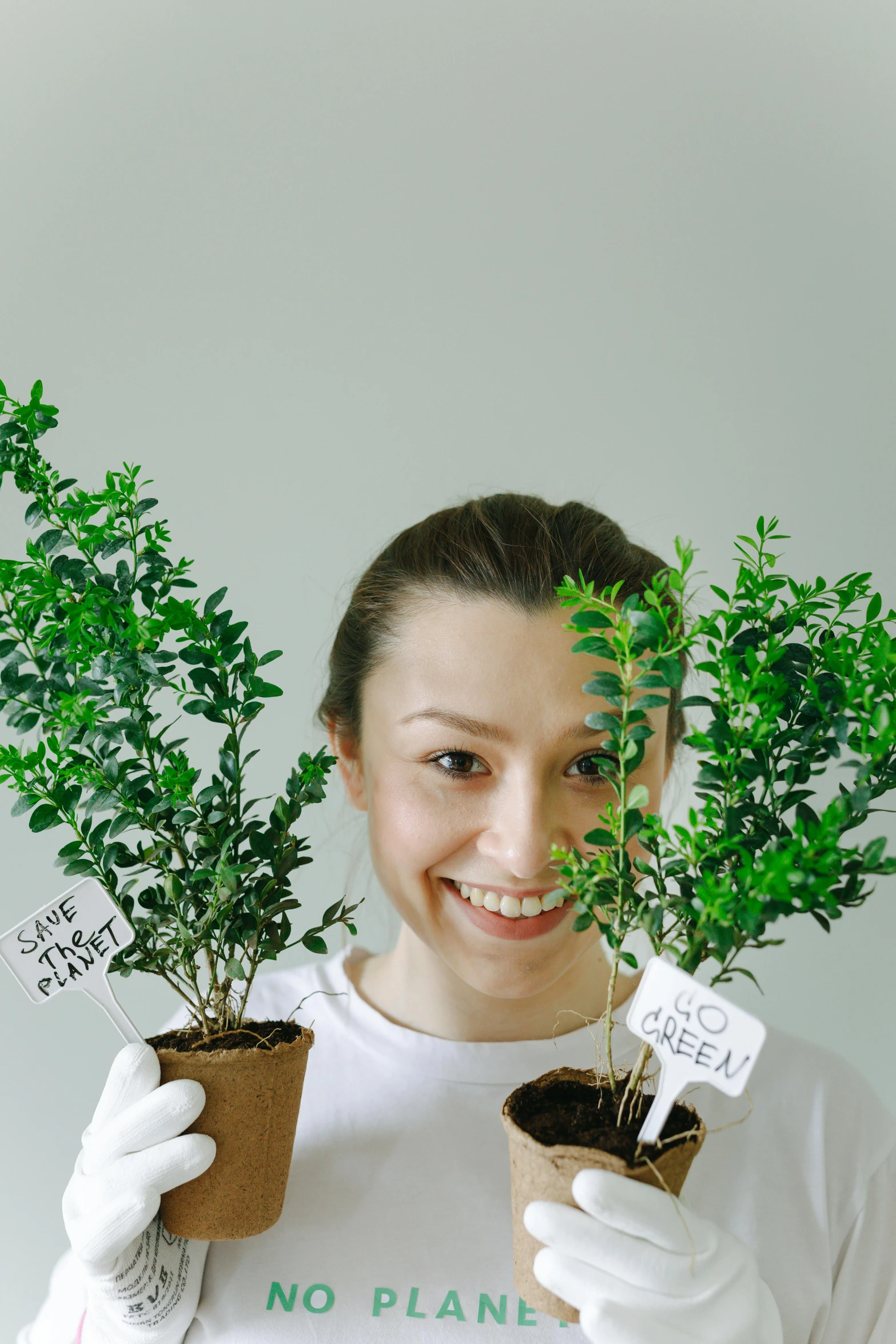 a woman in white gloves holding two potted plants, pexels contest winner, happy trees, some green, pokimane, product introduction photo