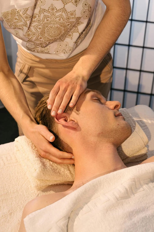 a woman getting a facial massage at a spa, trending on reddit, renaissance, square masculine jaw, greeting hand on head, concept photo, male face and bust