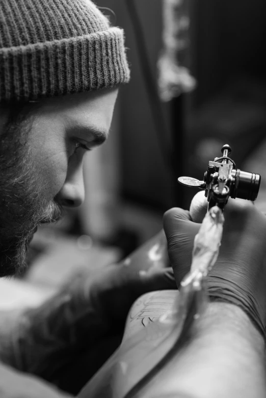 a man getting a tattoo on his arm, an airbrush painting, by Adam Marczyński, pexels contest winner, process art, bw, stitching, plating, traditional art