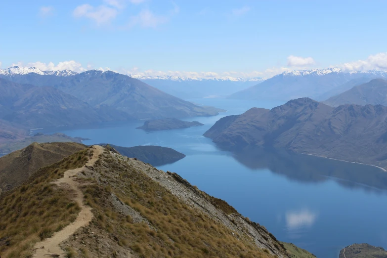 a view of a lake and mountains from the top of a mountain, by Charlotte Harding, pexels contest winner, hurufiyya, picton blue, slide show, walking down, 8 k -