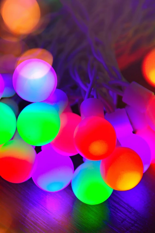 a bunch of colorful lights sitting on top of a table, pearlescent, superpop ultrabright, holiday season, 16-bit rgb