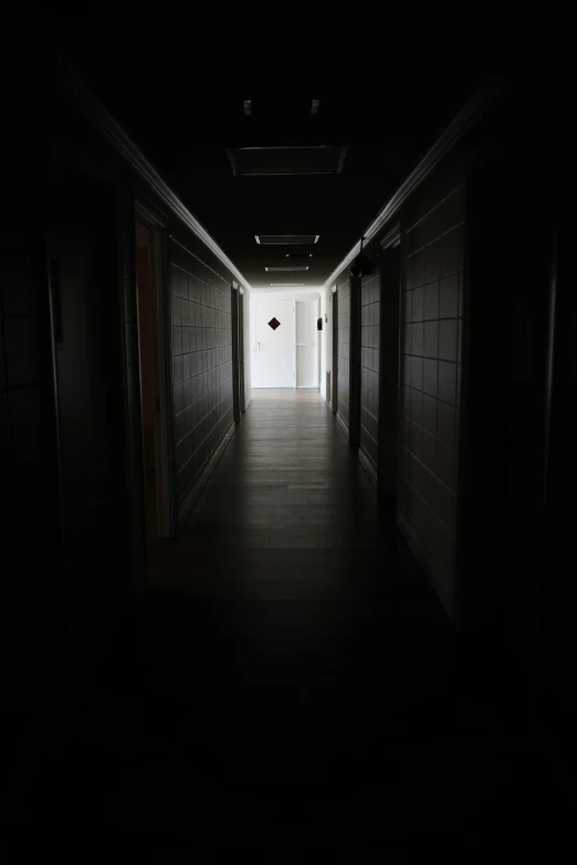 a dark hallway with a light at the end, 5 th floor, horror themed, ignant, depressing image